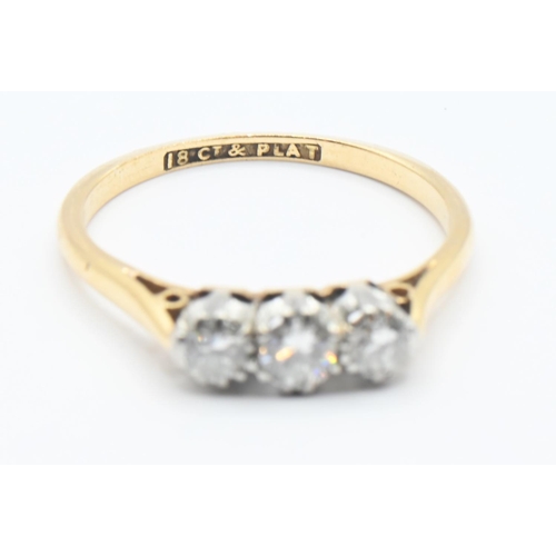 116 - 18ct gold and diamond trilogy ring featuring three brilliant cut diamonds mounted in platinum. Size ... 