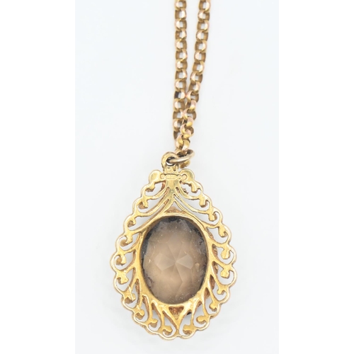 133 - 9ct gold chain, circumference 41cm with 9ct gold set smoky quartz pendant, length of pendant 30mm in... 