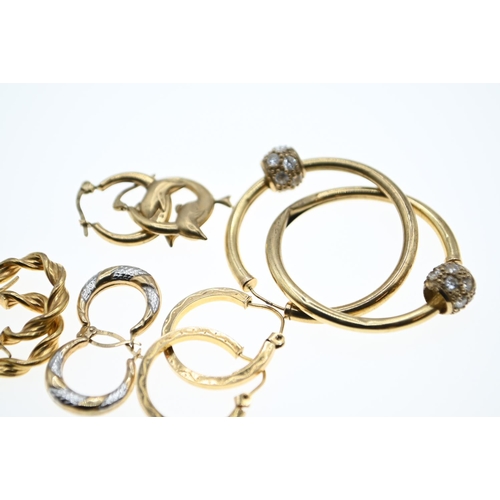 143 - Three pairs of 9ct gold hoop earrings, gross weight 2.7 grams together with two pairs of yellow meta... 