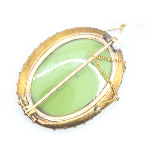 149 - Yellow metal oval mourning brooch set with five small diamonds. Gross weight 10.6g.