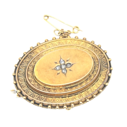 149 - Yellow metal oval mourning brooch set with five small diamonds. Gross weight 10.6g.