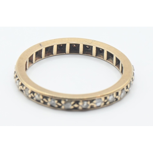 169 - Yellow metal eternity ring set with diamonds. Size N/O. Gross weight 2.29g