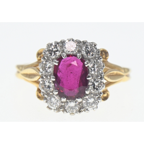 194 - 18ct gold, ruby and diamond cluster ring, the oval cut ruby displaying good colour of approximately ... 