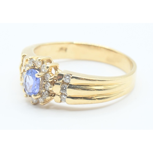 200 - 14ct gold, tanzanite and diamond cluster ring with diamond set shoulders, size P/Q, gross weight 3.8... 