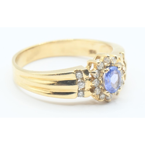 200 - 14ct gold, tanzanite and diamond cluster ring with diamond set shoulders, size P/Q, gross weight 3.8... 