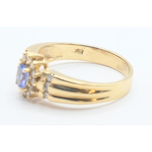 200 - 14ct gold, tanzanite and diamond cluster ring with diamond set shoulders, size P/Q, gross weight 3.8... 