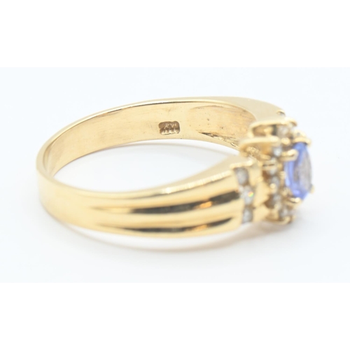 200 - 14ct gold, tanzanite and diamond cluster ring with diamond set shoulders, size P/Q, gross weight 3.8... 