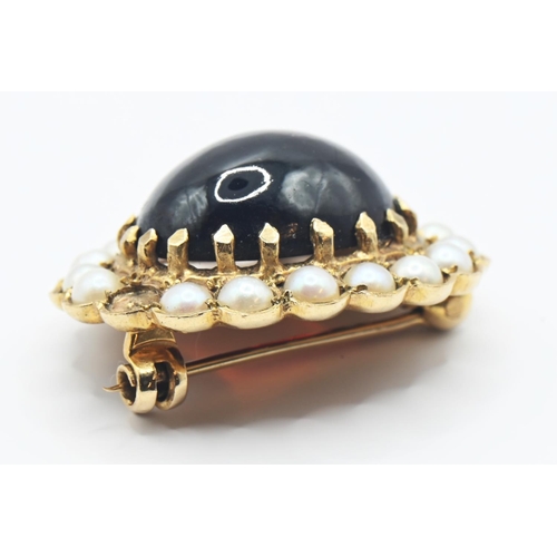 218 - 9ct gold brooch set with oval cabochon garnet 15mm x 10mm and split seed pearls (one missing). gross... 