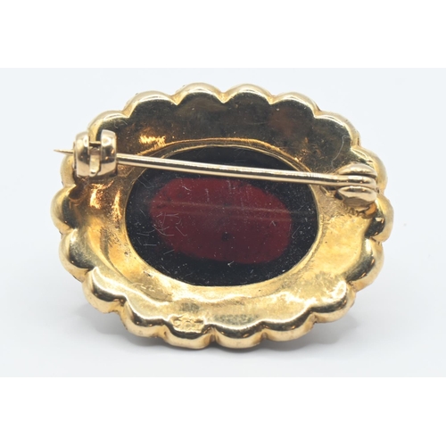 218 - 9ct gold brooch set with oval cabochon garnet 15mm x 10mm and split seed pearls (one missing). gross... 