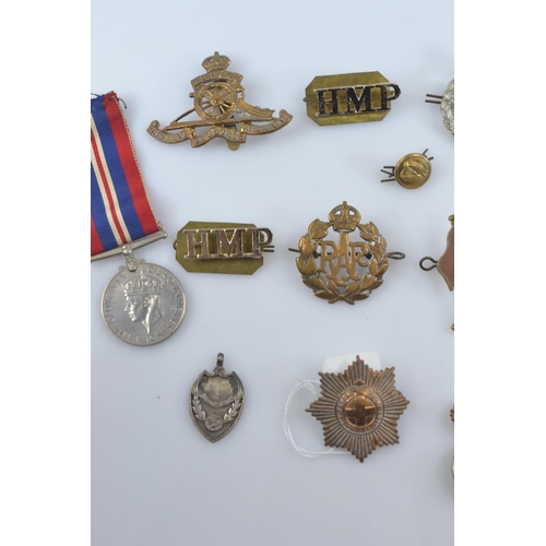 357 - WWII Defence medal and 1939-1945 war medal together with assorted cap badges, buttons and fabric bad... 