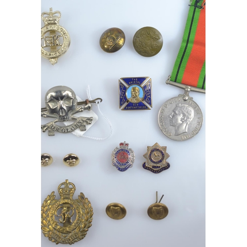 357 - WWII Defence medal and 1939-1945 war medal together with assorted cap badges, buttons and fabric bad... 