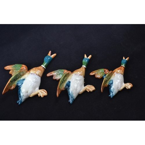 438 - A set of three graduated Beswick flying duck wall pockets 596-2, 3 & 4