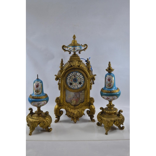 442 - Gilt metal and hand painted porcelain three piece mantle clock garniture, late C19th/early C20th, de... 