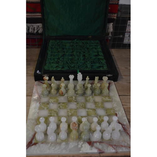 493 - Onyx chess board 41x41cm and chess pieces in a velvet purpose made case.