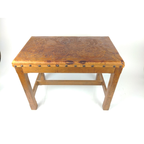 496 - Embossed leather topped stool in oak, in southern European style.