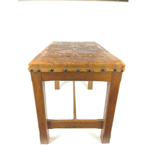 496 - Embossed leather topped stool in oak, in southern European style.