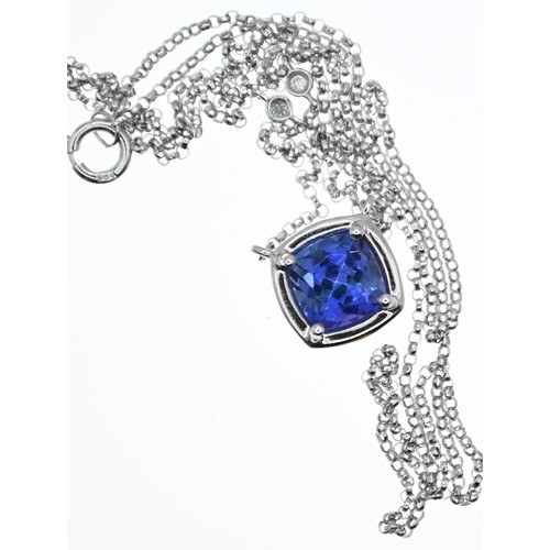 168 - 14ct white gold and tanzanite pendant necklace, with a spectacle-set diamond either side, circumfere... 