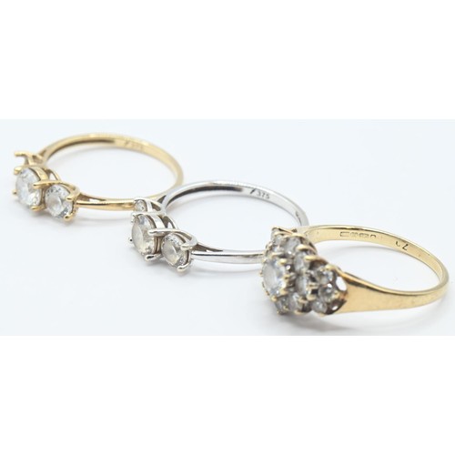 107 - Three 9ct gold rings set with CZ, sizes K-M, gross weight 5.21 grams, one stone missing