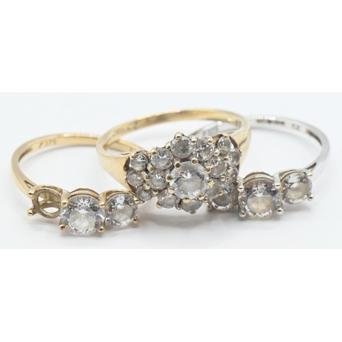 107 - Three 9ct gold rings set with CZ, sizes K-M, gross weight 5.21 grams, one stone missing