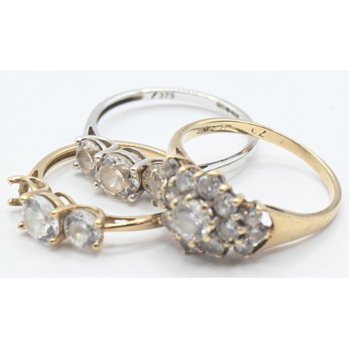 107 - Three 9ct gold rings set with CZ, sizes K-M, gross weight 5.21 grams, one stone missing