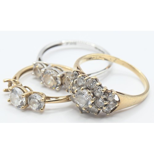 107 - Three 9ct gold rings set with CZ, sizes K-M, gross weight 5.21 grams, one stone missing