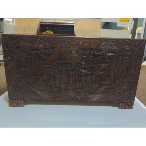 417 - Camphor wood heavily carved trunk 'Victoria Brand', made in Hong Kong. W110 x D53 x H57cm