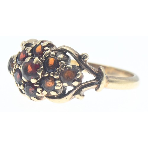 112 - Yellow metal and garnet cluster ring, tests positive for 9ct gold, size R, gross weight 3.74 grams