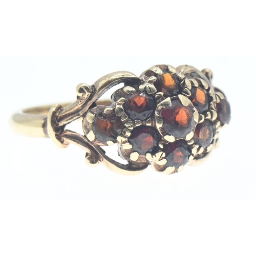 112 - Yellow metal and garnet cluster ring, tests positive for 9ct gold, size R, gross weight 3.74 grams