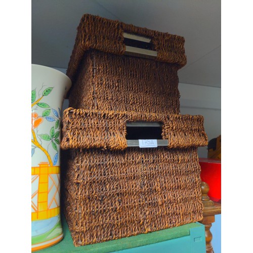 175A - Pair of modern wicker and steel storage baskets.