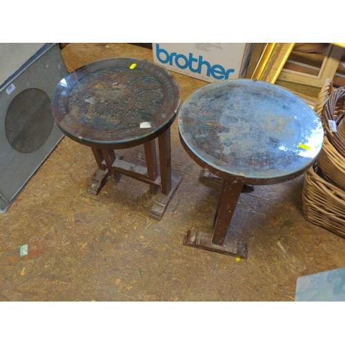 191 - Set of three heavily carved tilt top tables with glazed top featuring, Asian scenes. 