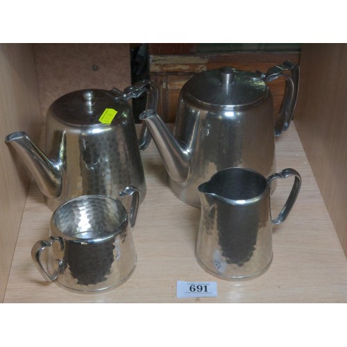 691 - Four pieces of hammered plate ware, two tea pots, milk and sugar.