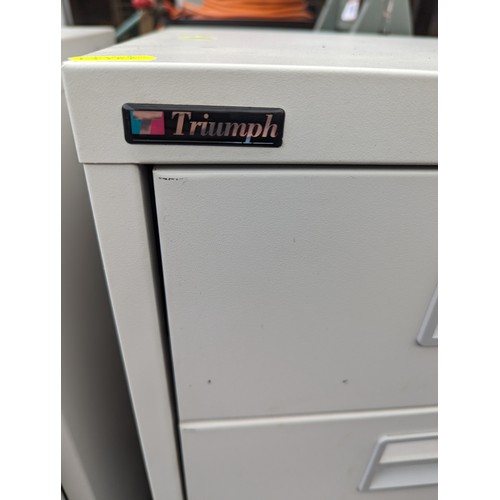 312A - Two metal filing cabinets by Triumph both 4 drawers. 40 X 40 X 64 CM