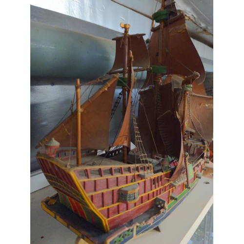 468 - Model galleon with four masts and sails in period style with twelve canon on a stand.