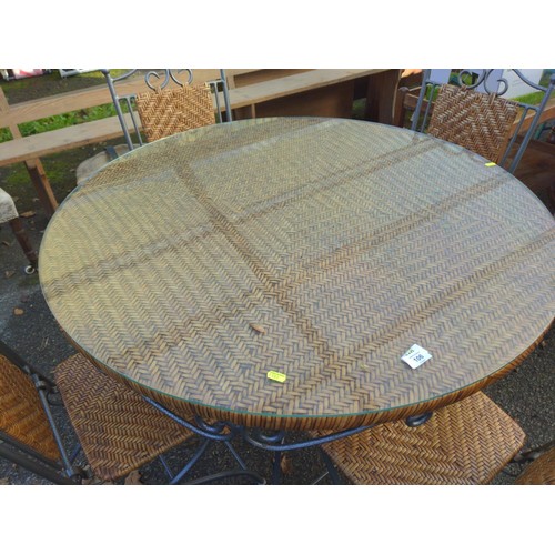 106 - Metal and rattan circular garden table and four folding chairs, glass top to table. D101cm x H76cm