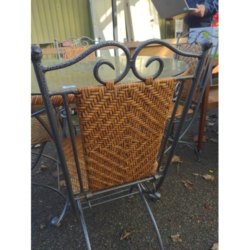 106 - Metal and rattan circular garden table and four folding chairs, glass top to table. D101cm x H76cm