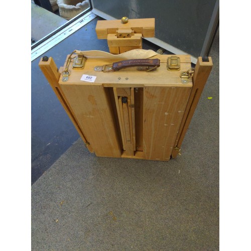 289 - Portable artists box with standing legs and easel .