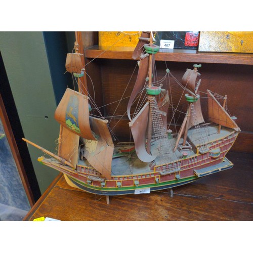 468 - Model galleon with four masts and sails in period style with twelve canon on a stand.