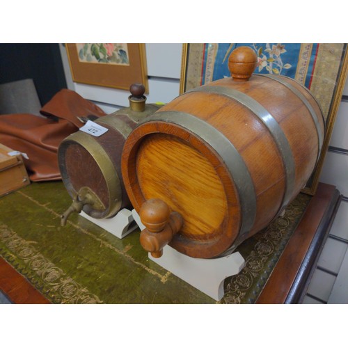 472 - 2 small oak barrels on stands. Largest L25cm