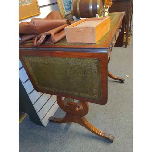 473 - Small leather topped double drop end side table. On castors with lyre ended supports. L148cm extende... 