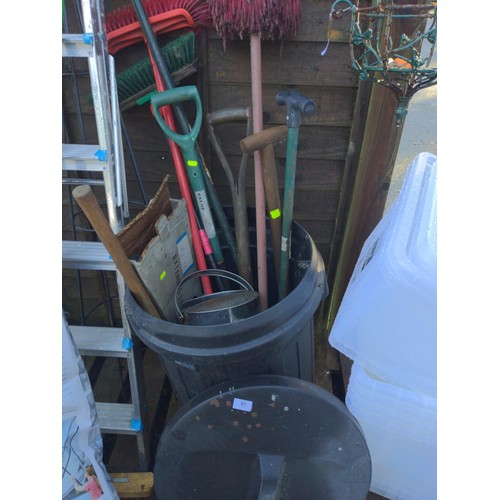 61 - Black plastic bin with mostly long handled tools.