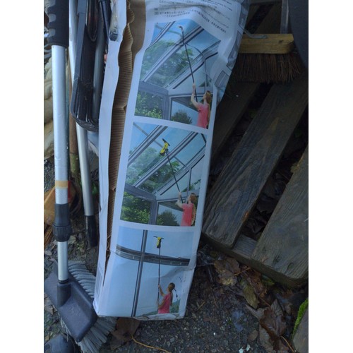 61 - Black plastic bin with mostly long handled tools.