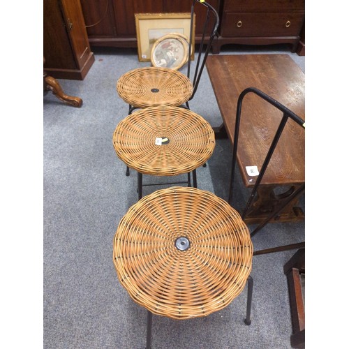 553 - Two mid-century steel framed chairs and matching occasional table with cane tops.