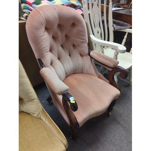 559 - Plush upholstered button back mahogany armchair with original castors. height to back 95 cm