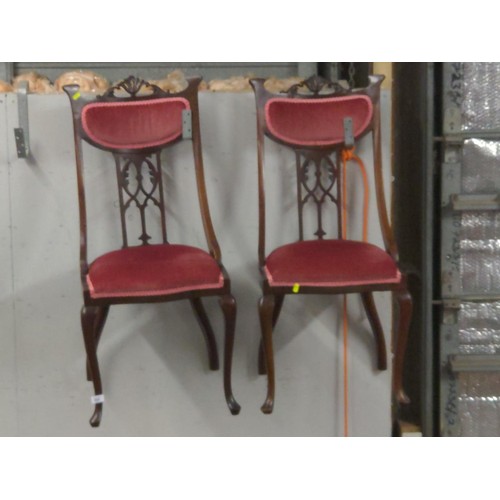 889 - Pair of ornate designed mahogany dining chairs with burgundy fabric seats and back.