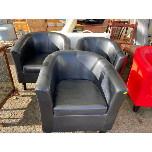117 - Three black leather effect club chairs.
