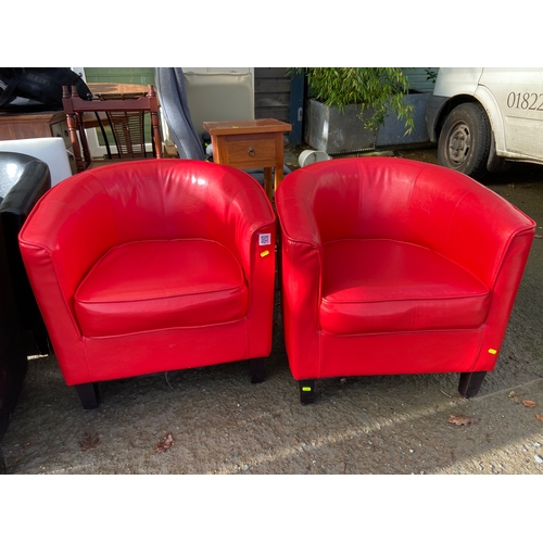 122 - Two red leather effect club chairs.
