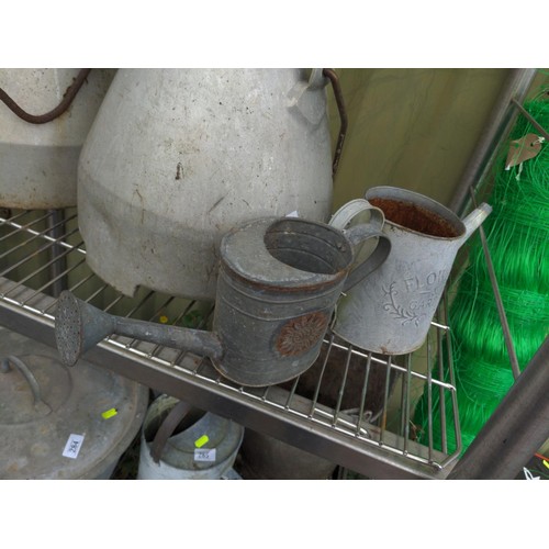 133 - Pair of aluminium small watering cans, largest H16cm