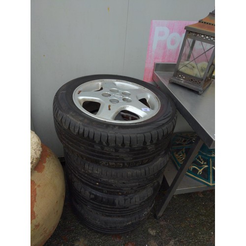 145 - Four Nissan alloy wheels and tyres 205 55 R16 