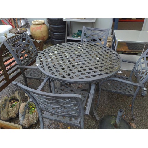 5 - Cast aluminium lattice style garden seating set, with 4 chairs and parasol stand. Table D110cm