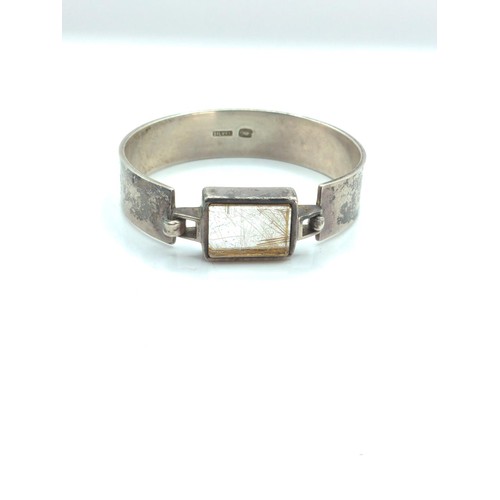 664 - Silver and rutilated quartz bracelet, marked 'silver' with fish skeleton stamp, inner diameter 59mm,... 